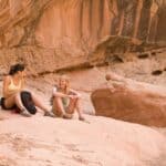 Rock climbers relaxing on boulder